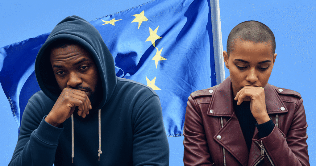 Un hombre y una mujer negros con expresiones de tristeza y preocupación, con la bandera de la Unión Europea difuminada al fondo, simbolizando el impacto de los crímenes de odio en la diversidad europea.